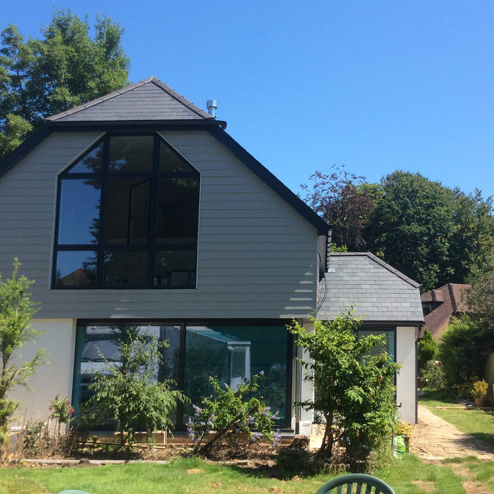 Featured Image. Large new build, with natural slate roof. Solar panels.