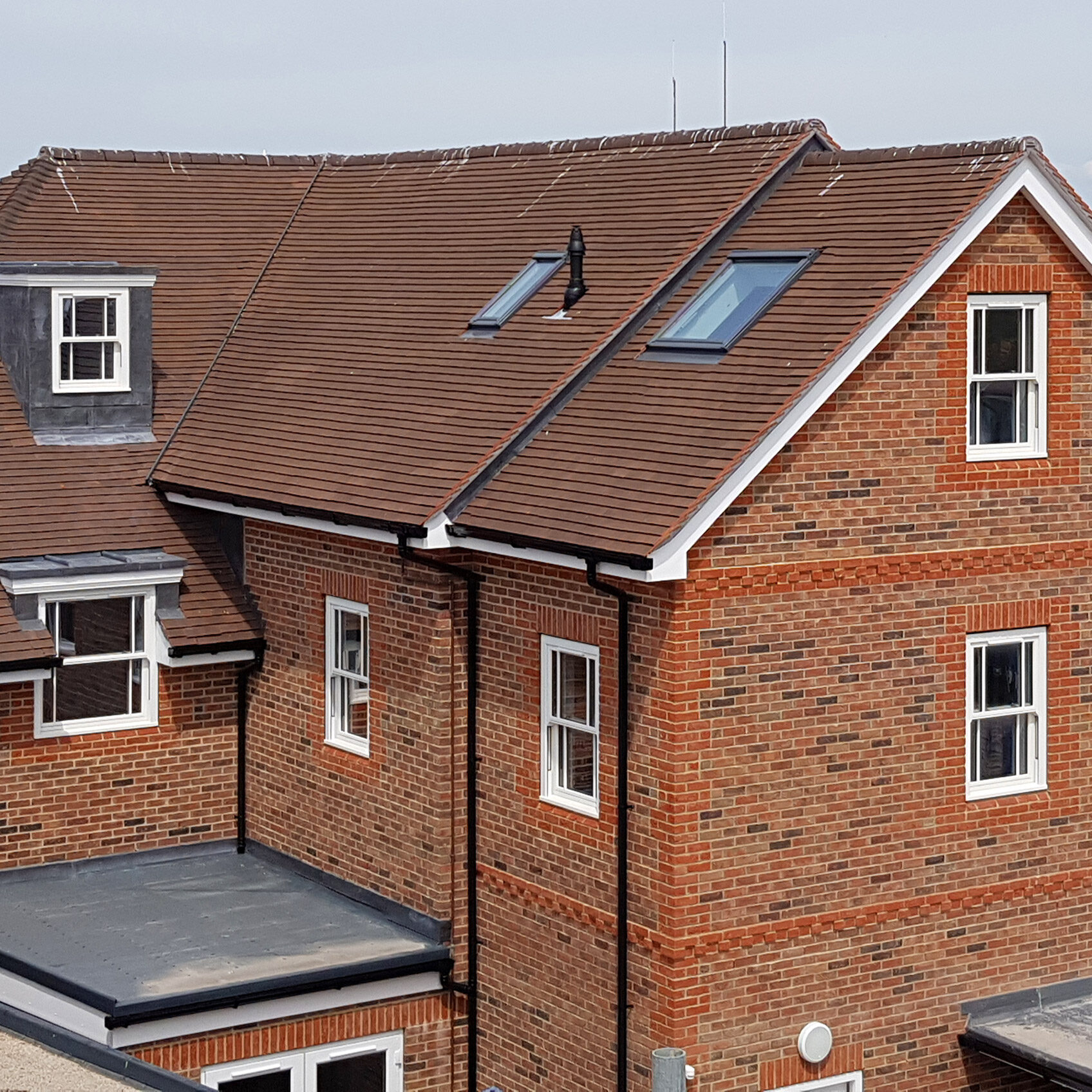 New build roofing. Machine made Clay plain tiles and lead dormers.