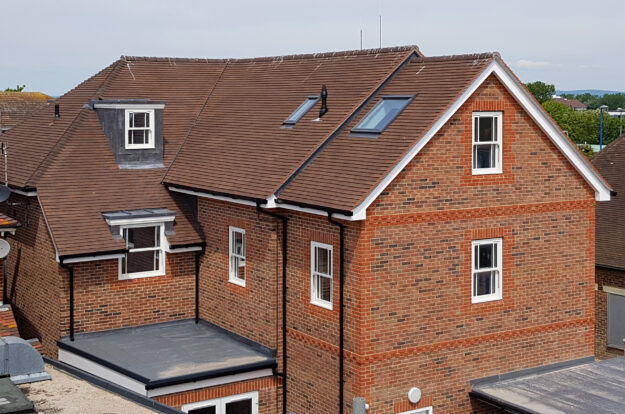 New build roofing. Machine made Clay plain tiles and lead dormers.