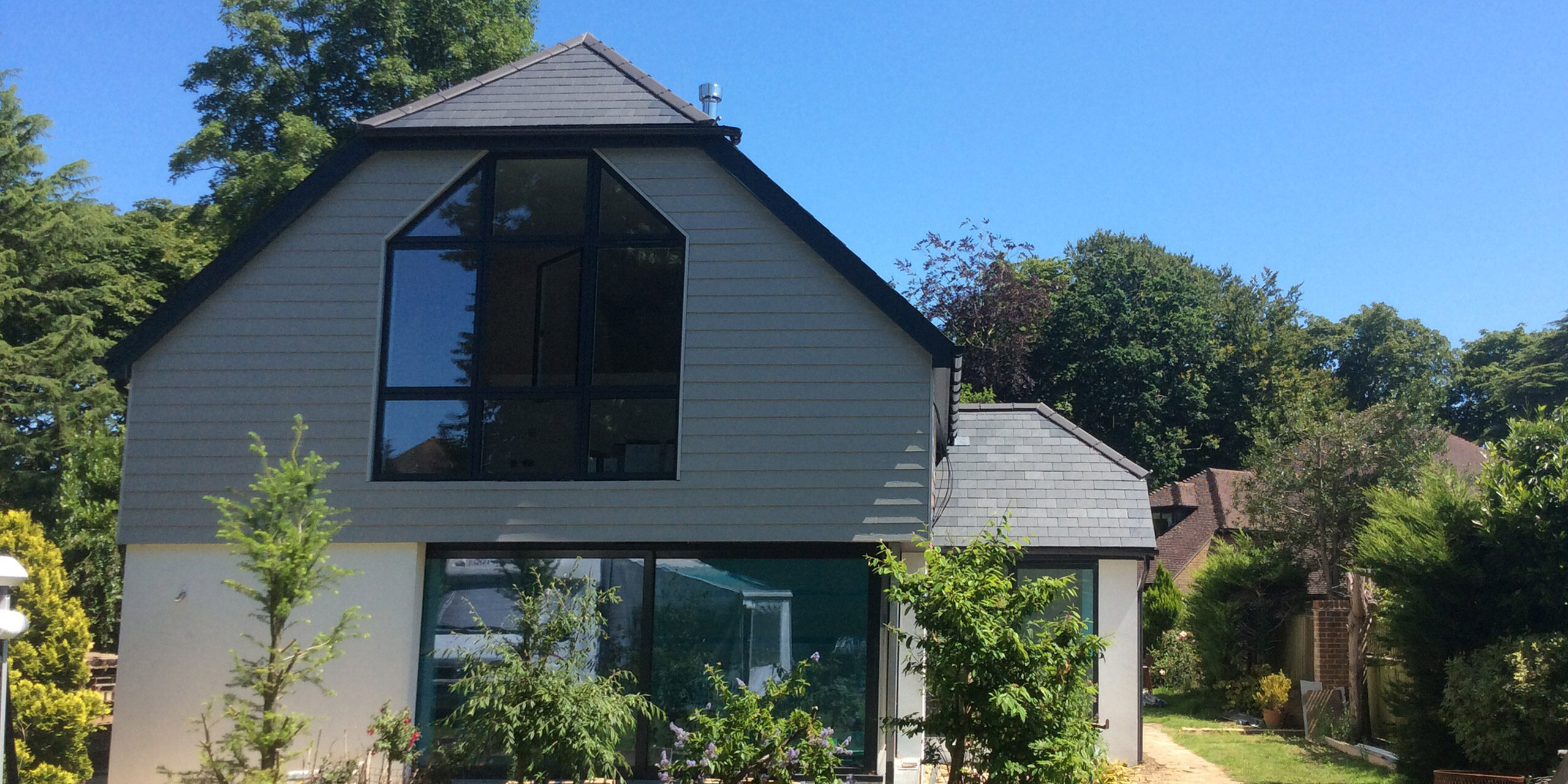 Featured Image. Large new build, with natural slate roof. Solar panels.