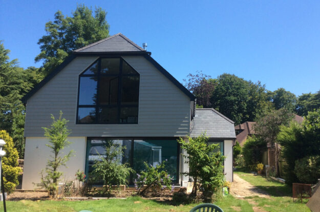 Featured Image. Large new build, with natural slate roof. Solar panels.